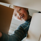 Young boy looking into box, smiling at what's inside
