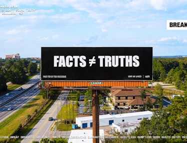A billboard that reads "Facts ≠ Truths".