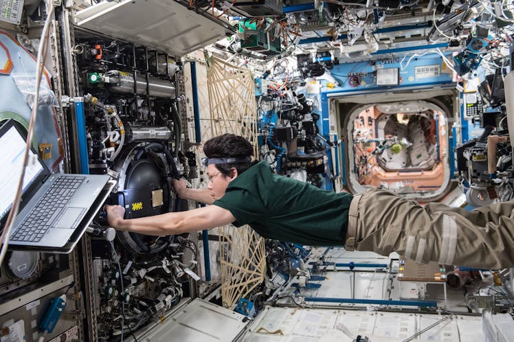 JAXA astronaut Norishige Kanai working on an ISS experiment.