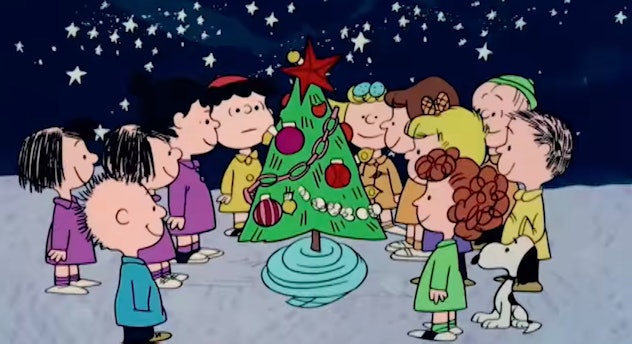 Still from 'A Charlie Brown Christmas'; the whole cast gathers around the Christmas tree with Charli...
