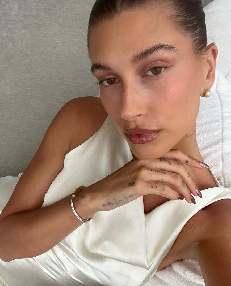 Hailey Bieber taking a selfie at home where she also inspires TikTokers to show off how to make Hail...