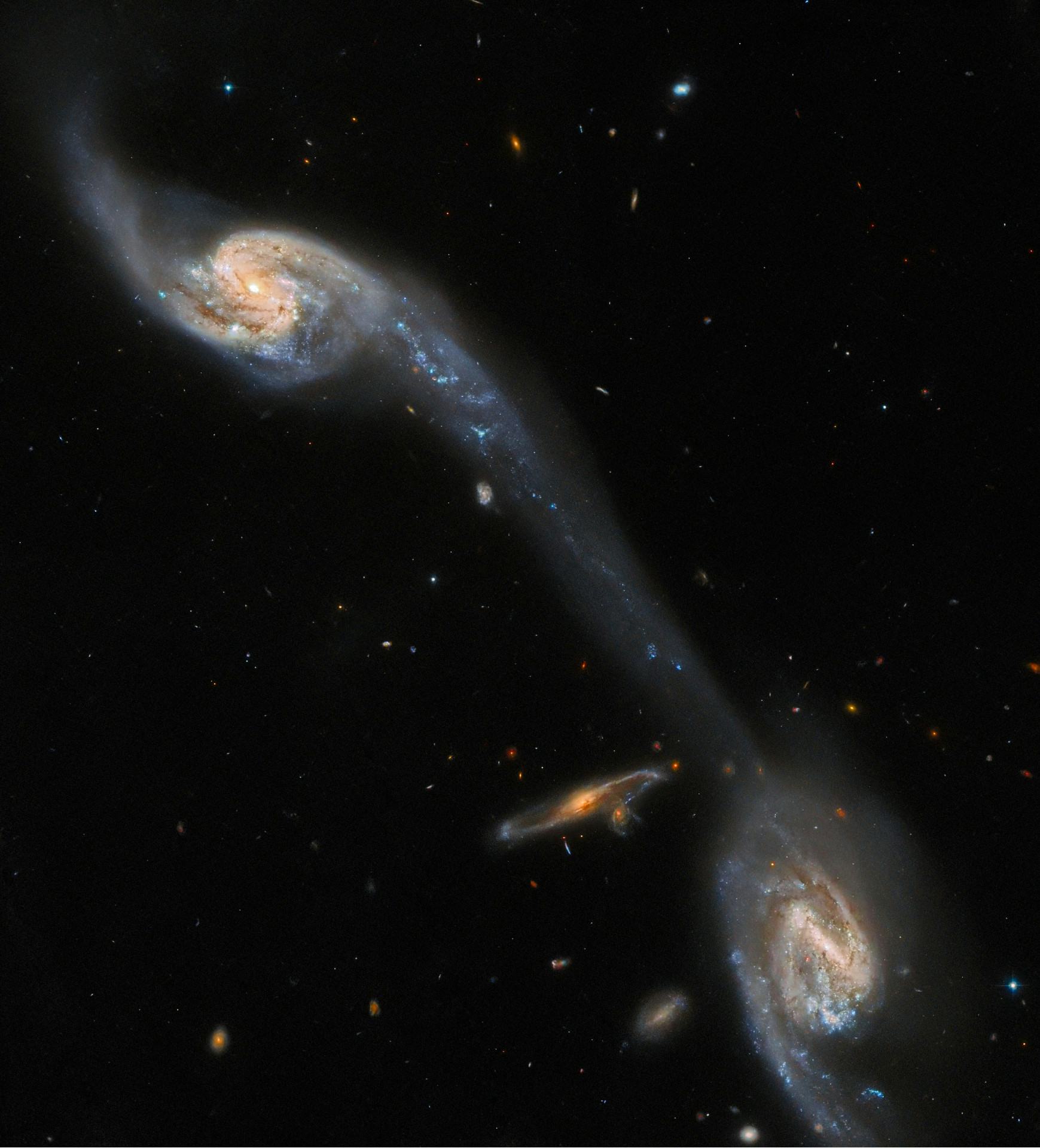 This image from the NASA/ESA Hubble Space Telescope shows two of the galaxies in the galactic triple...