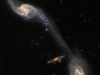 This image from the NASA/ESA Hubble Space Telescope shows two of the galaxies in the galactic triple...