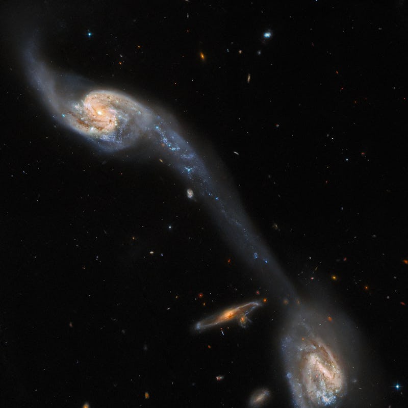 This image from the NASA/ESA Hubble Space Telescope shows two of the galaxies in the galactic triple...