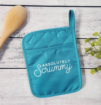 A teal oven mitt that reads "Absolutely Scrummy," a Great British Bake Off gift idea