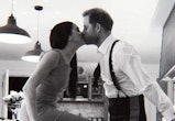Harry and Meghan kiss in the kitchen of their cottage.