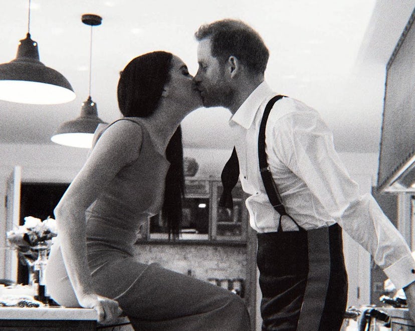 Harry and Meghan kiss in the kitchen of their cottage.