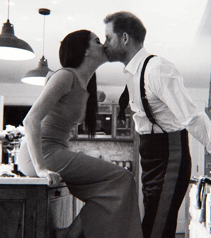 Harry and Meghan kiss in the kitchen of their cottage.