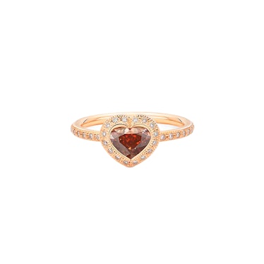 a ring with diamonds and a heart shaped ruby