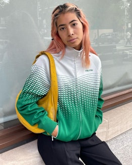 michelle li wearing a green and white jacket