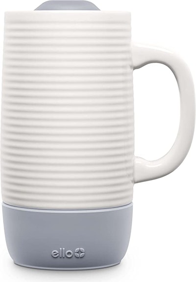 A white ceramic mug with ridged texture and a light blue rubber base