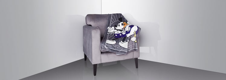 The Disney100 celebration merch includes a new throw blanket with Mickey Mouse and friends. 