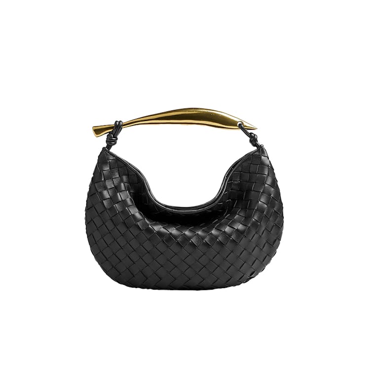 a woven leather bag with a gold handle