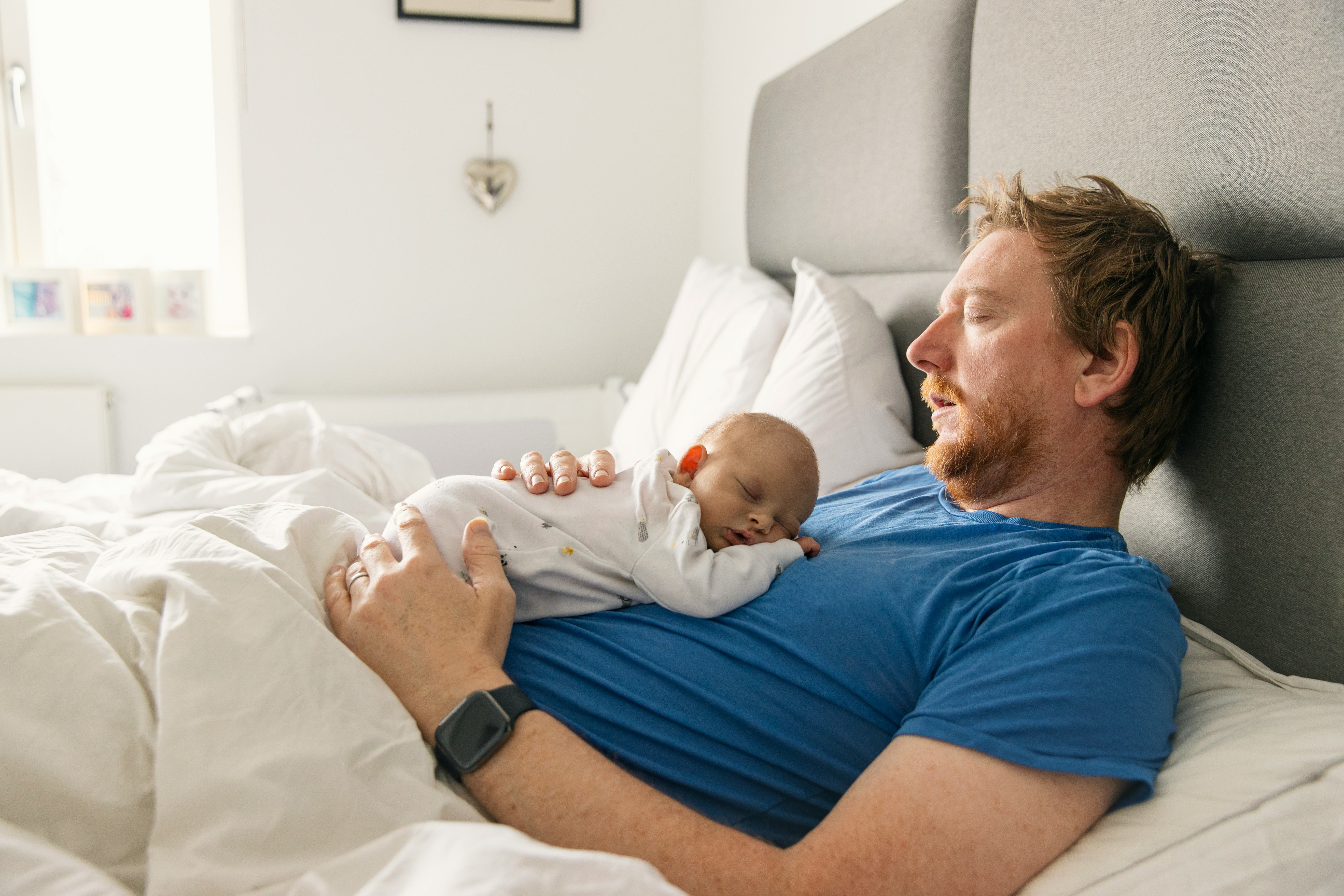 Newborn sleeping on top parents chest