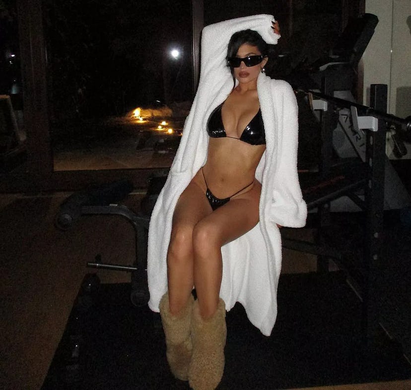 Kylie Jenner wearing a Good American bikini with shearling wedge boots from Loewe.