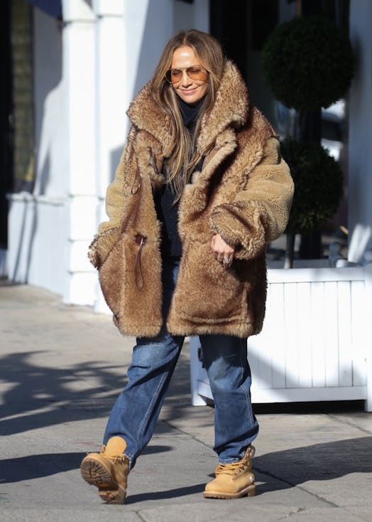 Jennifer Lopez wearing a fuzzy shearling coat from Coach.