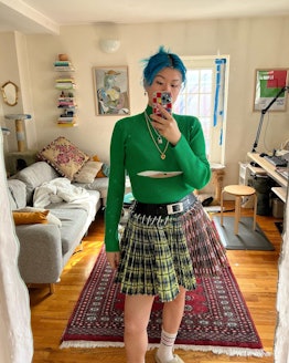 Mi-Anne wearing a green sweater and skirt
