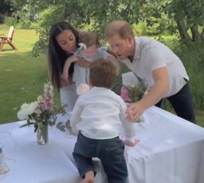The Sussexes blow out Lilibet's birthday candle.