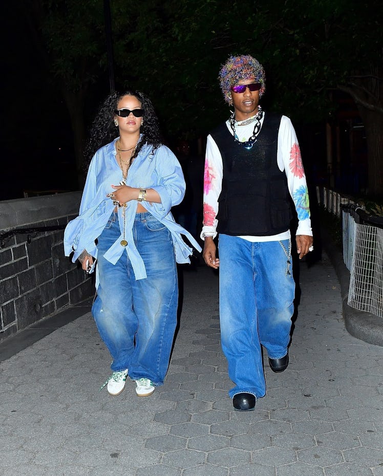 Rihanna and Asap rocky walking at nighttime both wearing big jeans