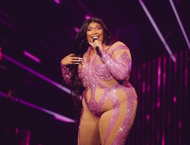 Lizzo performing in a glittery jumpsuit