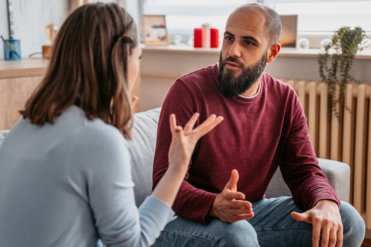 Couple sitting on couch having a serious discussion