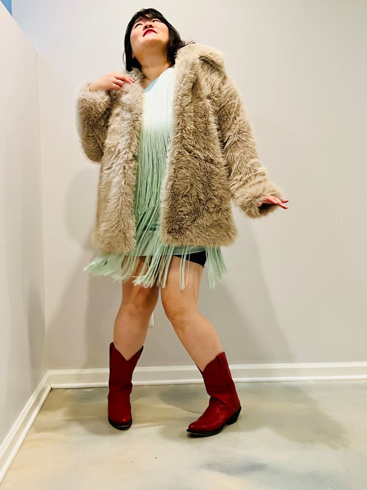 Michelle Yang in a fringed mini dress and faux fur coat from Nuuly Rent