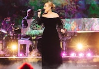 Adele wearing a black off-the-shoulder dress from Nina Ricci.