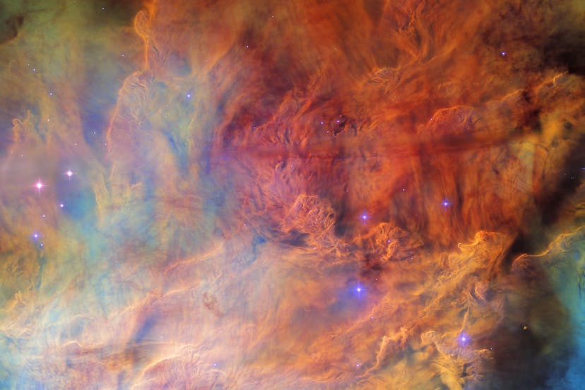 In every direction, cloudy waves and bands of red, orange, blue, green, and yellow crash over each o...