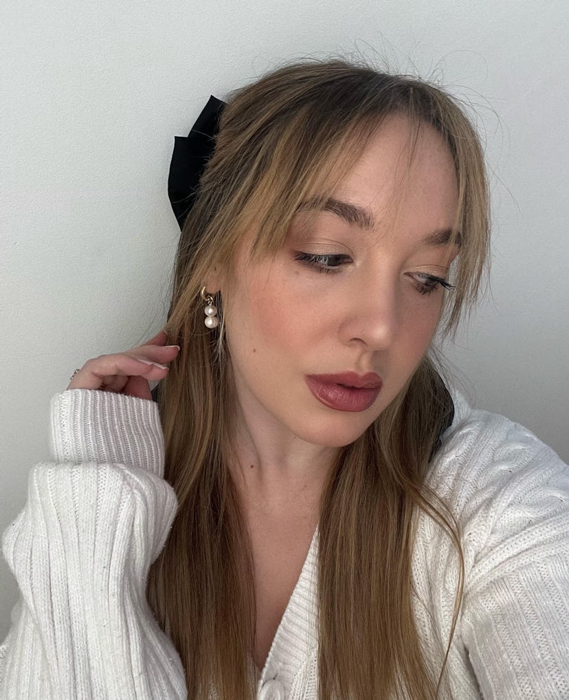 For all those wondering how to style bangs at home, Bustle beauty writer Olivia Rose Ferreiro shares...