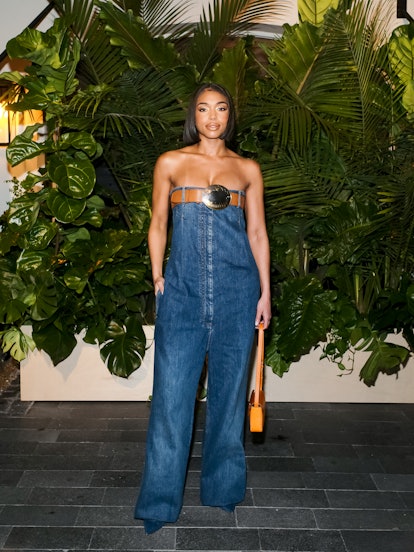 Lori Harvey wearing a denim jumpsuit from Burberry at  the Miami Art Basel 2022.