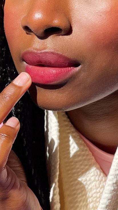 violette fr model applying bisou balm lipstick