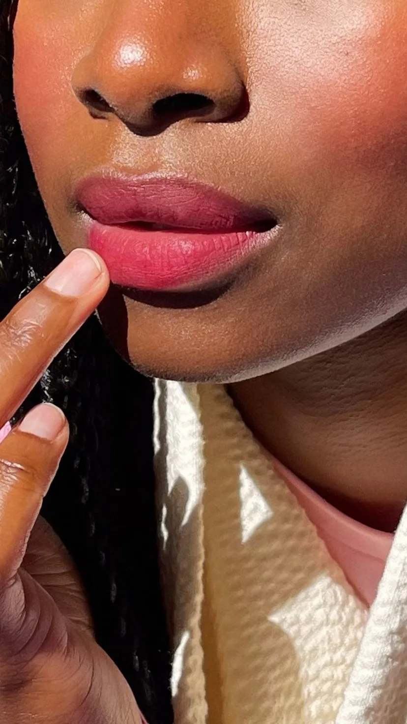 violette fr model applying bisou balm lipstick
