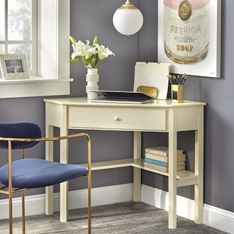 This elegant corner desk for small spaces has a storage drawer.