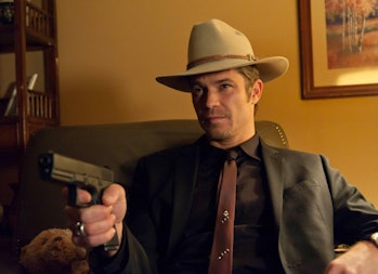 Raylan Givens (Timothy Olyphant) holds up a gun in FX's Justified