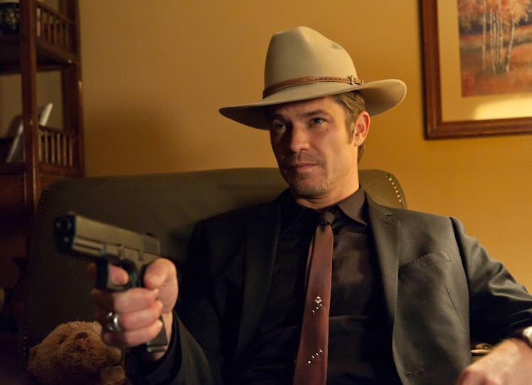 Raylan Givens (Timothy Olyphant) holds up a gun in FX's Justified