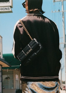 A model walks in LA wearing a Celine by Hedi Slimane bag