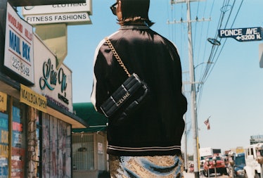 A model walks in LA wearing a Celine by Hedi Slimane bag