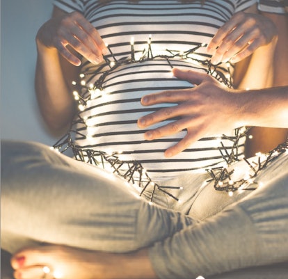 photo of pregnant belly with lights for a Christmas pregnancy announcement