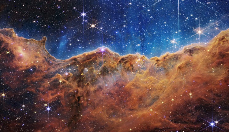 a giant cloud of stars and dust that looks like waves on the ocean or a cliff