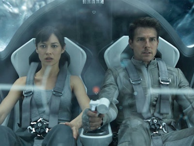 Male and female lead from Oblivion sitting in sci-fi transport vehicle