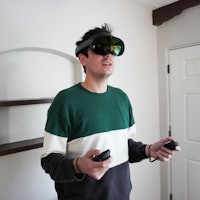 Inverse editor Ian Carlos Campbell wearing the Quest Pro VR headset and using Touch Pro controllers