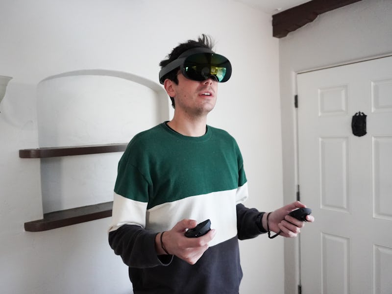 Inverse editor Ian Carlos Campbell wearing the Quest Pro VR headset and using Touch Pro controllers