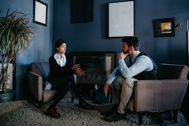 A man talks to a therapist in her office.