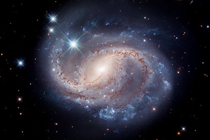 Against an inky black backdrop, the blue swirls of spiral galaxy NGC 6956 stand out radiantly.