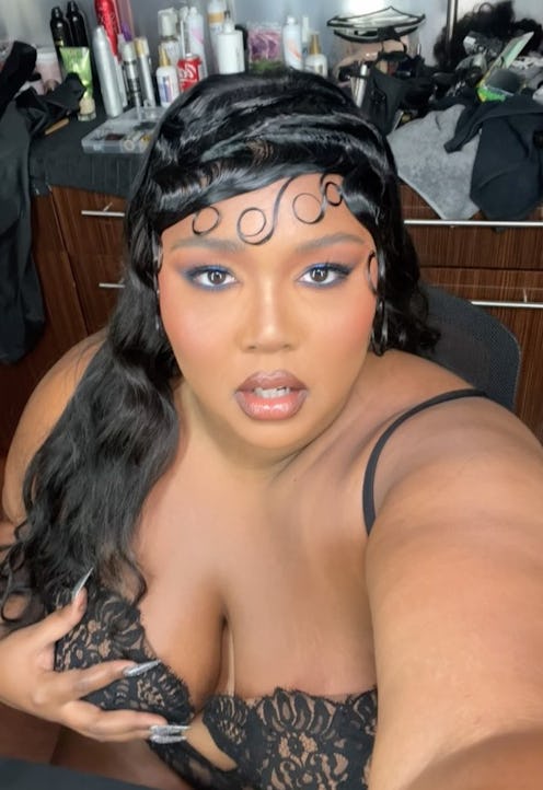 Lizzo debuted a wolf cut with bangs on TikTok. Her long hair was cut into shaggy, fluffy layers and ...