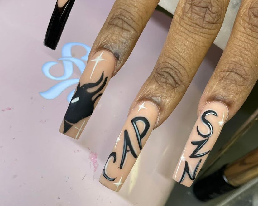 Capricorn nail designs with black and white graffiti-style font