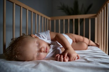 A baby sleeping in a crib