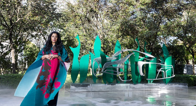 Suchi Reddy standing in front of one of her works at Miami Art Basel