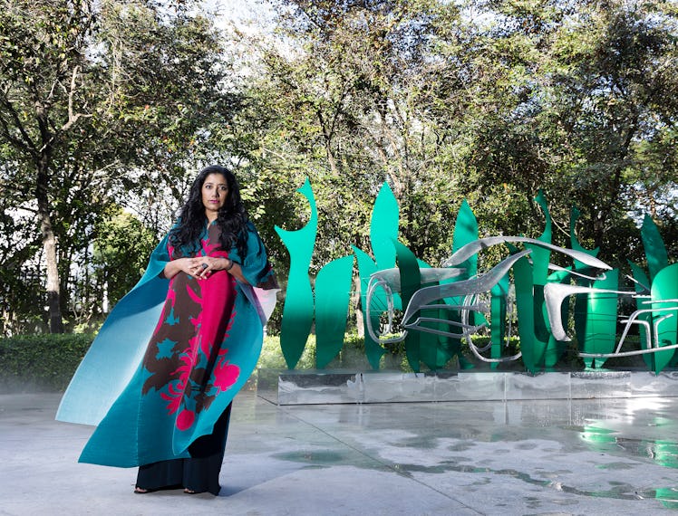 Suchi Reddy standing in front of one of her works at Miami Art Basel