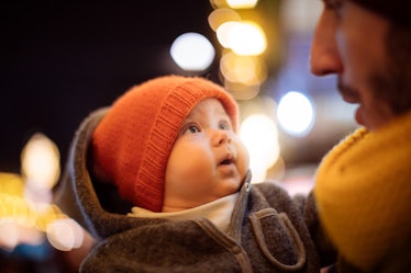 A baby with his dad outside in winter.